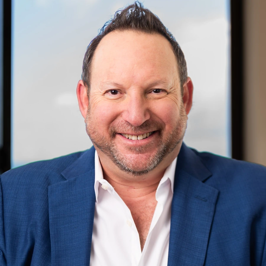 Michael N. Fineman, press headshot, smiling, in a blue blazer